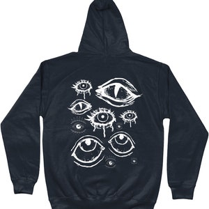 May include: A dark navy blue hooded sweatshirt with a white graphic print of multiple stylized eyes. The eyes are drawn in a variety of styles, some with tears, some with pupils, and some with a more abstract design.