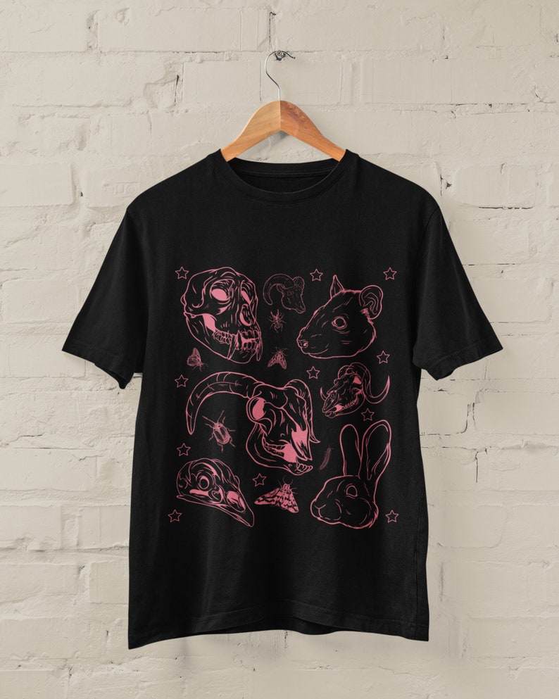 May include: Black t-shirt with a pink graphic print of various animal skulls, insects, and stars.