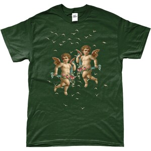 May include: A dark green t-shirt with a vintage illustration of two cherubs flying with flowers and ribbons. The cherubs are surrounded by white birds flying in the air.