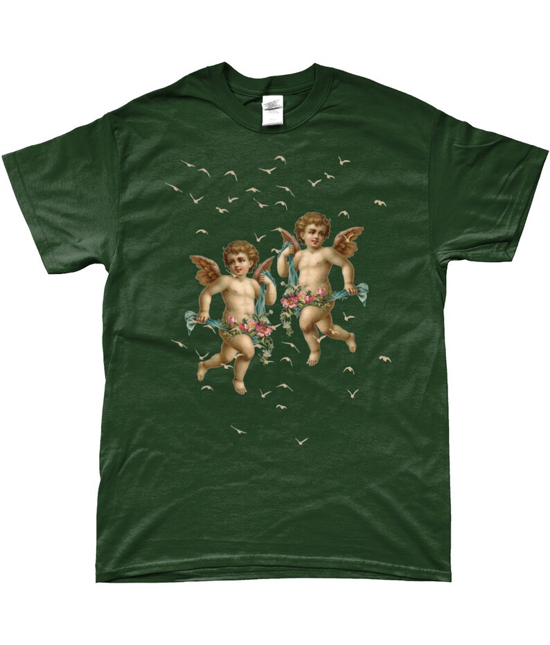 May include: A dark green t-shirt with a vintage illustration of two cherubs flying with flowers and ribbons. The cherubs are surrounded by white birds flying in the air.