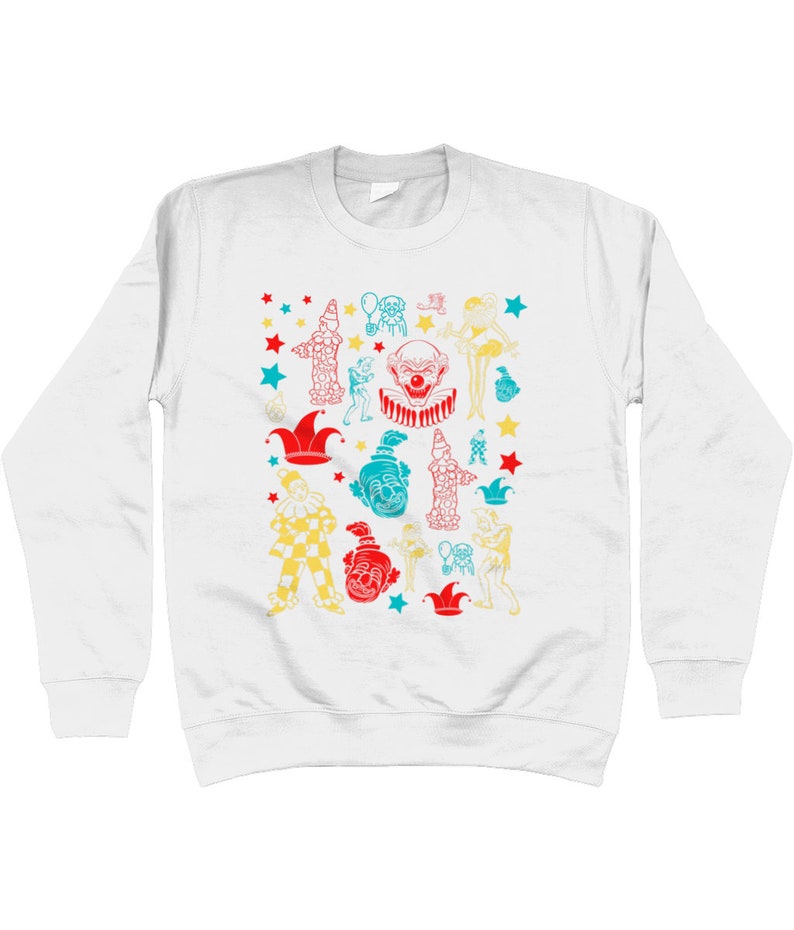 May include: White long-sleeve sweatshirt with a colorful pattern of clowns, stars, and hats. The design features a variety of clown faces, hats, and other circus-related imagery.