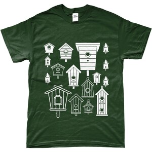 May include: A dark green t-shirt featuring a white design of various birdhouses. The birdhouses are all different shapes and sizes, and some have small holes for birds to enter.