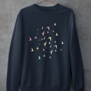 May include: A dark blue sweatshirt featuring a design of colourful birds flying in a circular pattern.