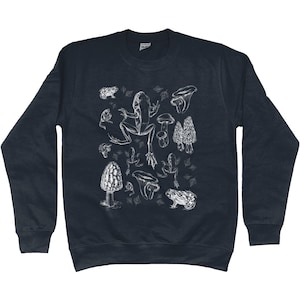 May include: A dark blue sweatshirt with a white graphic print of a frog, mushrooms, and toadstools.