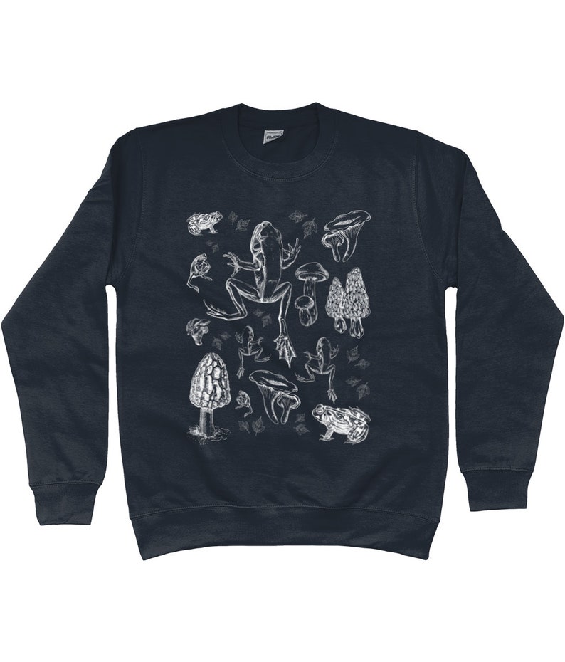 May include: A dark blue sweatshirt with a white graphic print of a frog, mushrooms, and toadstools.