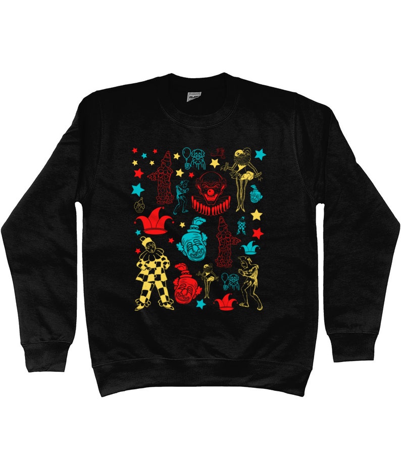 May include: Black sweatshirt with a colorful pattern of clowns, stars, and other circus-themed imagery.