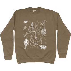 May include: A brown sweatshirt with a white print of various mushrooms, frogs, and toadstools.