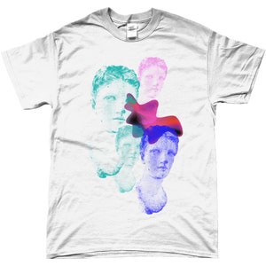 May include: White t-shirt with a graphic design of three blue, green, and pink stylized faces with a red, pink, and blue abstract shape.