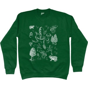 May include: A green sweatshirt with a white print of a frog, mushrooms, and leaves. The print is a vintage style illustration.