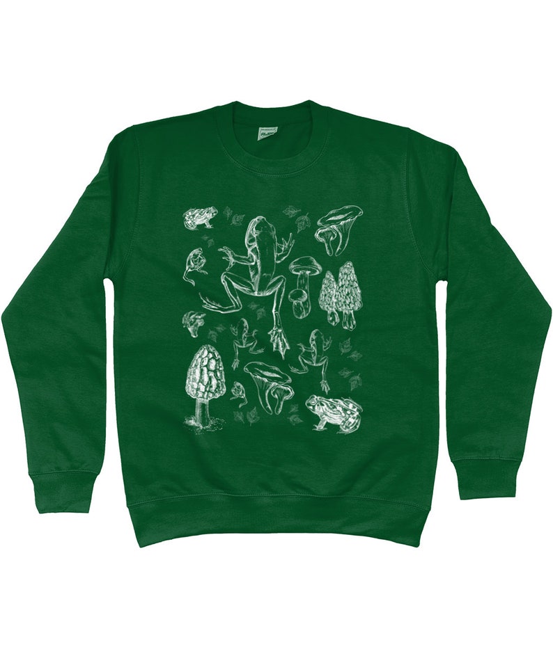 May include: A green sweatshirt with a white print of a frog, mushrooms, and leaves. The print is a vintage style illustration.