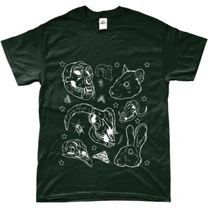 May include: A dark green t-shirt with a white design of animal skulls, insects, and stars. The design includes a monkey skull, a ram skull, a rabbit skull, a rabbit, a moth, and a beetle.