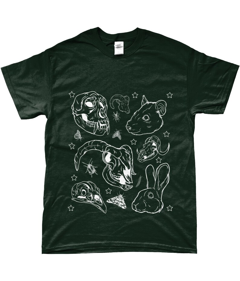 May include: A dark green t-shirt with a white design of animal skulls, insects, and stars. The design includes a monkey skull, a ram skull, a rabbit skull, a rabbit, a moth, and a beetle.