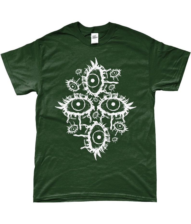 May include: A dark green t-shirt with a white graphic print of multiple stylized eyes. The eyes are drawn in a creepy, abstract style.