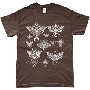 May include: A brown t-shirt with a white graphic print of moths and crescent moons. The moths are surrounded by geometric shapes.