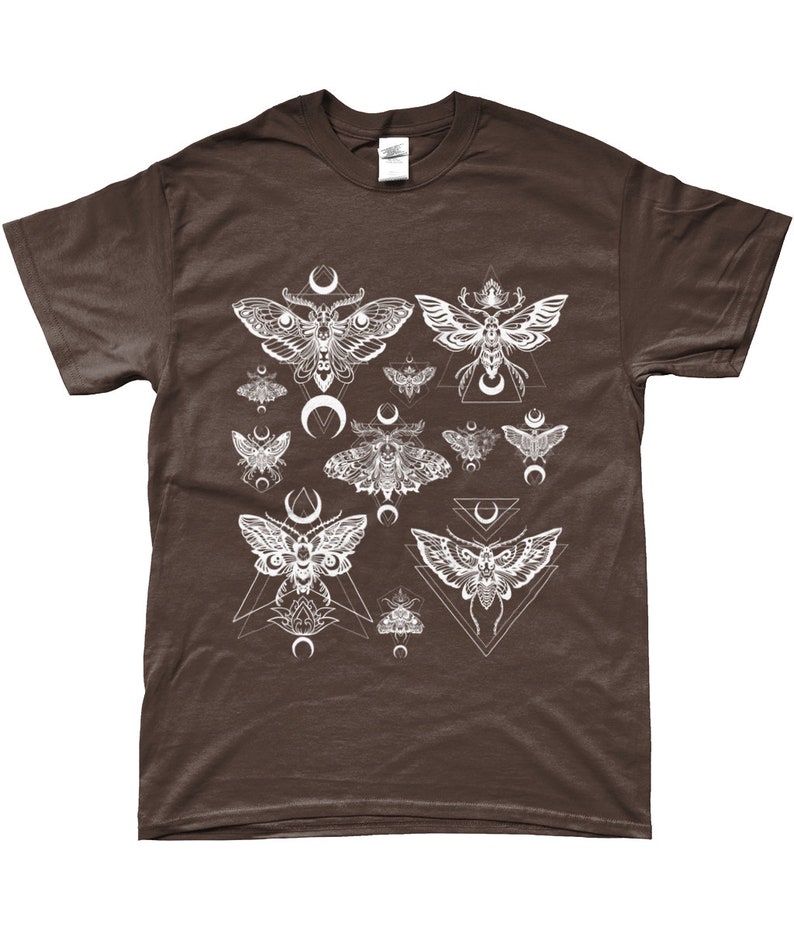 May include: A brown t-shirt with a white graphic print of moths and crescent moons. The moths are surrounded by geometric shapes.