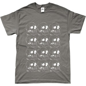 May include: A charcoal gray t-shirt with a white skull pattern. The skulls are arranged in a repeating pattern across the front of the shirt.