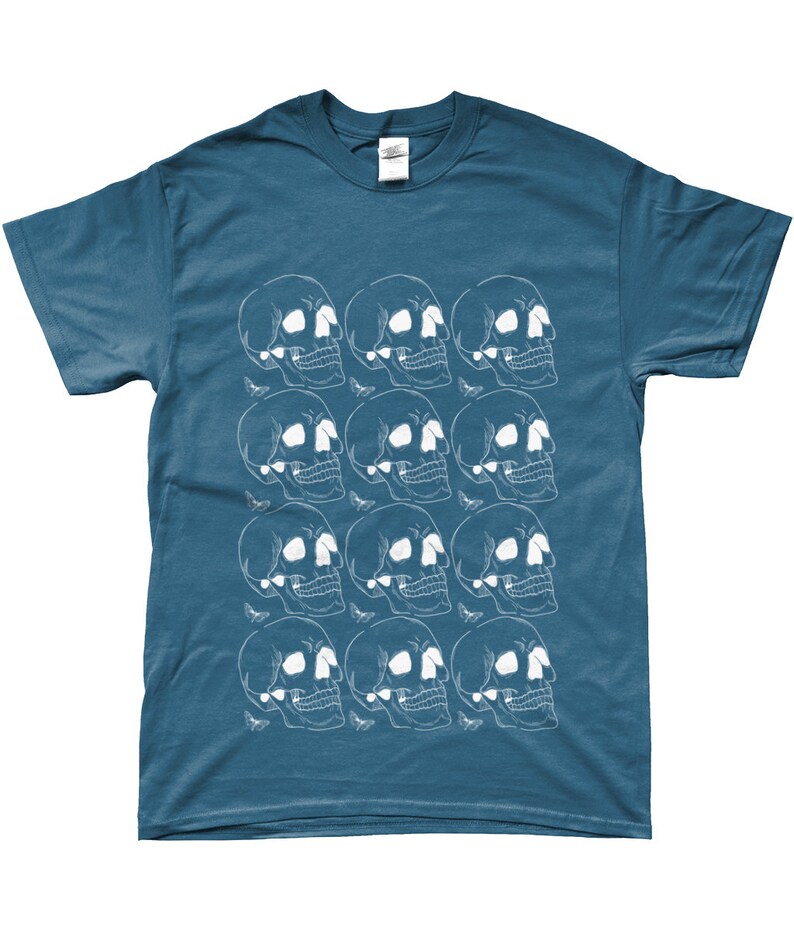 May include: A teal blue t-shirt with a white graphic print of a repeating pattern of skulls.