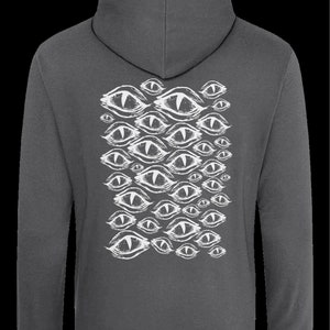 May include: A charcoal gray hooded sweatshirt with a white print of multiple stylized eyes on the back.