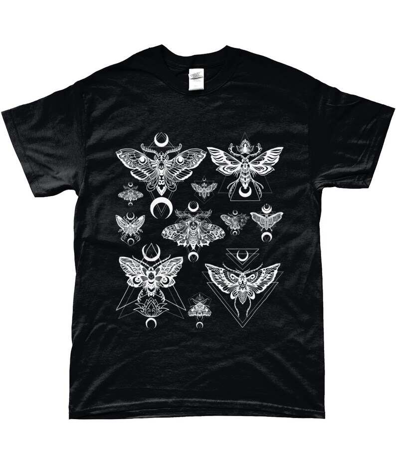 May include: Black t-shirt with a white graphic print of moths and geometric shapes. The moths are stylized and have intricate details. The geometric shapes are triangles and crescents.