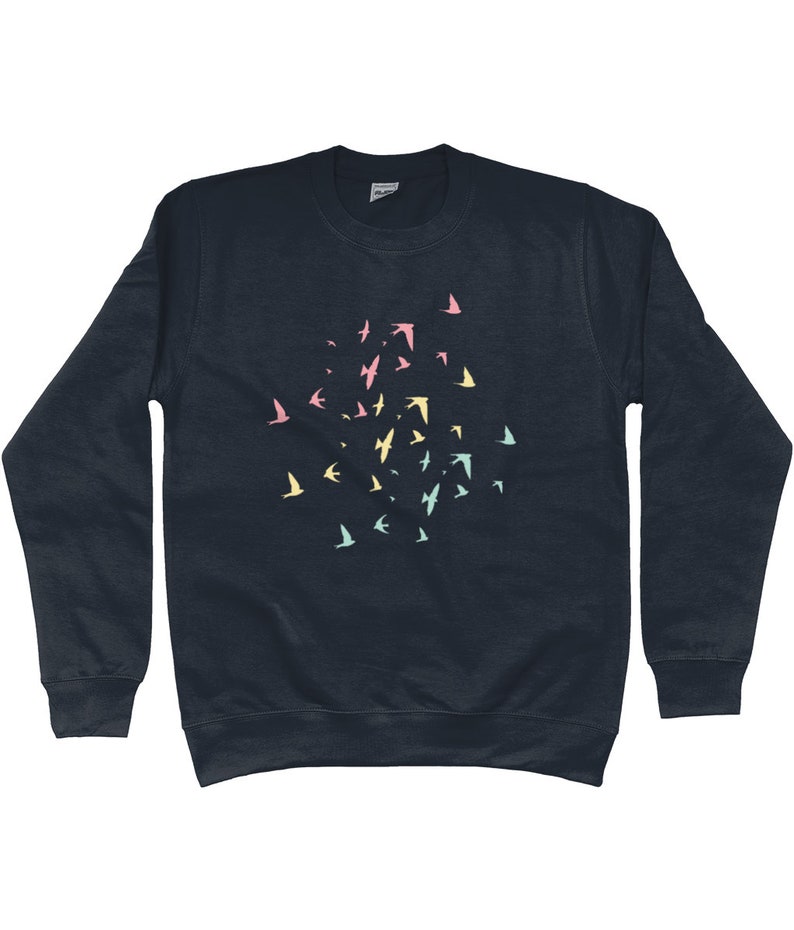May include: A dark navy blue sweatshirt with a flock of pastel coloured birds printed on the front.