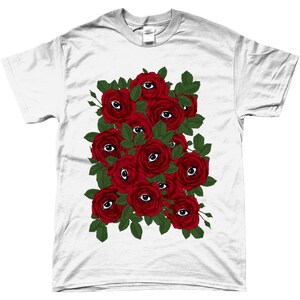 May include: White t-shirt with a graphic design of red roses with eyes in the center of each rose.