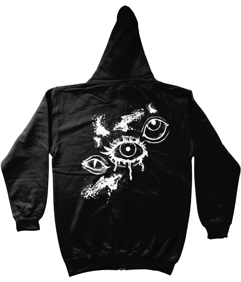 May include: Black zippered hoodie with a white graphic of three stylized eyes with dripping paint.