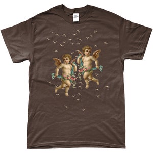 May include: A brown t-shirt with a print of two cherubs with wings, holding flowers and flying among a flock of birds.