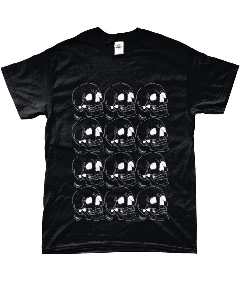May include: Black t-shirt with a white skull and butterfly pattern. The skulls are arranged in a repeating pattern across the front of the shirt.