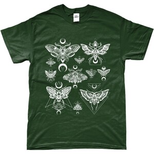 May include: A dark green t-shirt with a white print of moths and geometric shapes. The moths are stylized and have a crescent moon design.