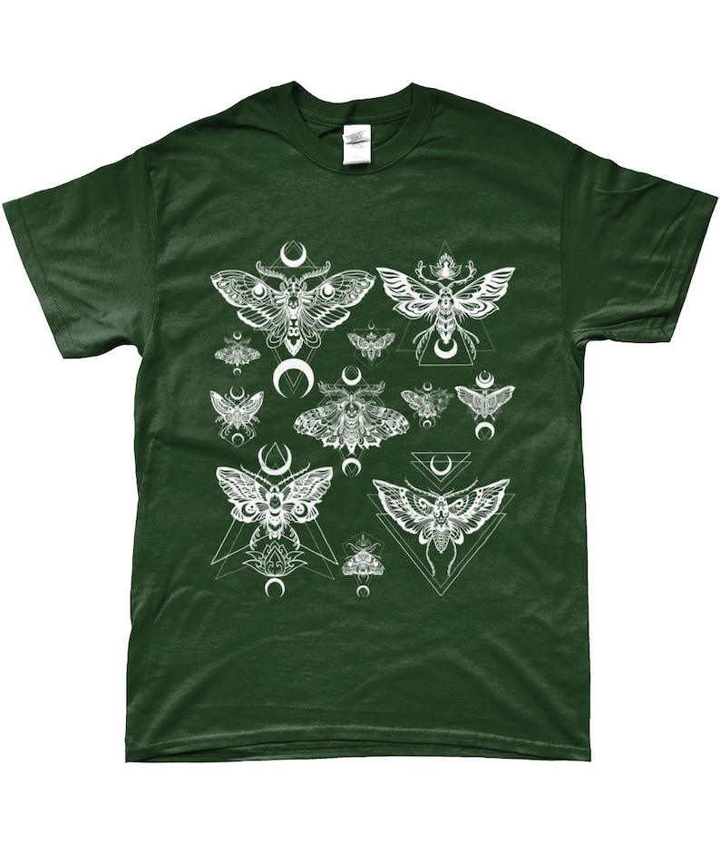 May include: A dark green t-shirt with a white print of moths and geometric shapes. The moths are stylized and have a crescent moon design.
