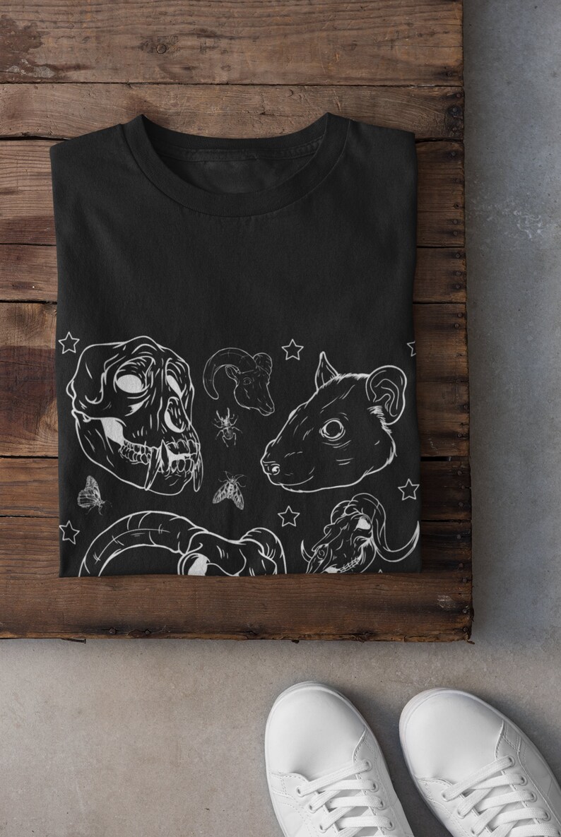 May include: Black t-shirt with a white graphic design featuring animal skulls, stars, and insects.