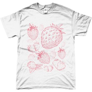 May include: White t-shirt with a pink strawberry print. The strawberries are drawn in a vintage style and are scattered across the shirt.