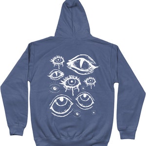 May include: A dark blue hooded sweatshirt with a white graphic print of multiple eyes on the back.