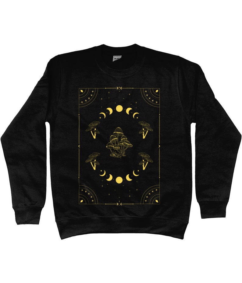 May include: Black sweatshirt with a gold graphic design featuring mushrooms, moons, and stars within a geometric frame.