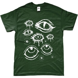 May include: A dark green t-shirt with a white graphic print of multiple stylized eyes. The eyes are drawn in a creepy, abstract style.