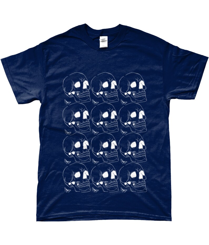 May include: A navy blue t-shirt with a white skull and butterfly pattern. The skulls are arranged in a grid pattern and the butterflies are scattered throughout the design.