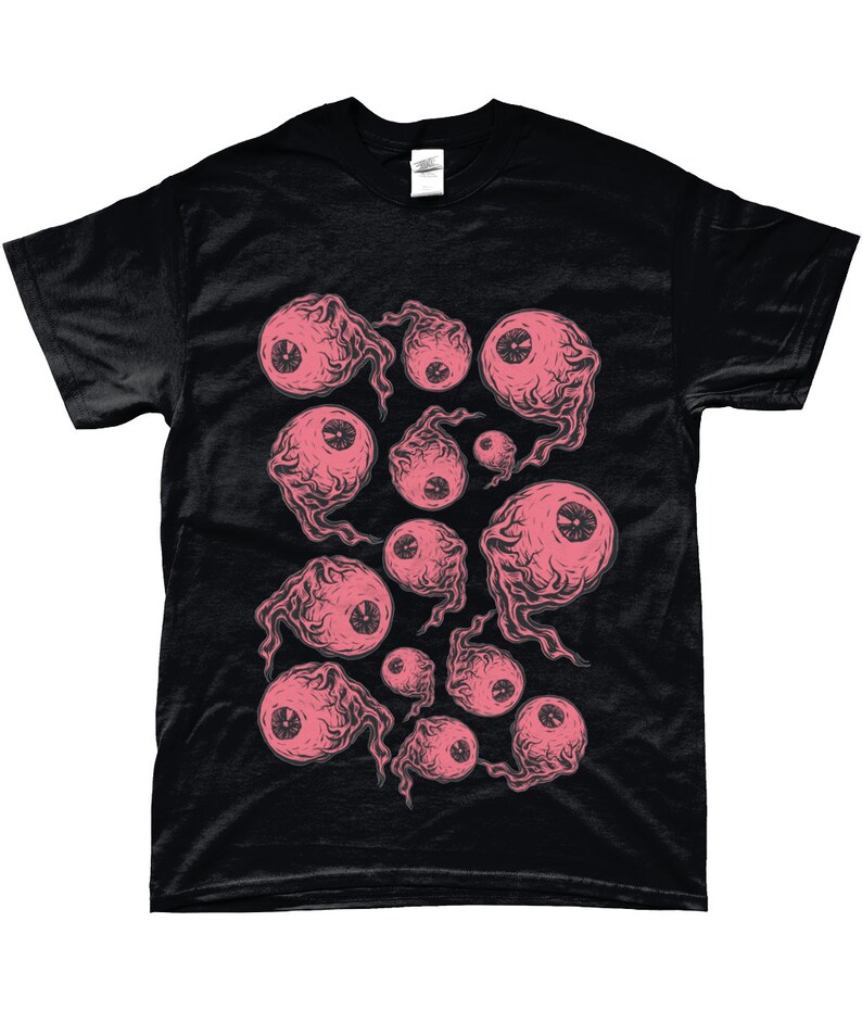 May include: Black t-shirt with a pink and white eye pattern. The eyes are drawn in a cartoon style and have a creepy, whimsical look.