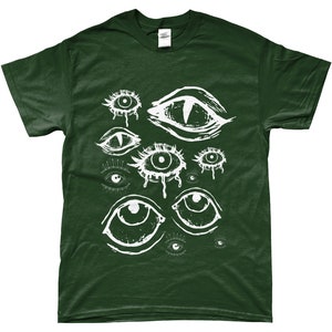 May include: Dark green t-shirt featuring a white graphic of various stylized eyes. The eyes have different shapes and sizes, with some appearing to be crying. The design is printed on a short-sleeved shirt.