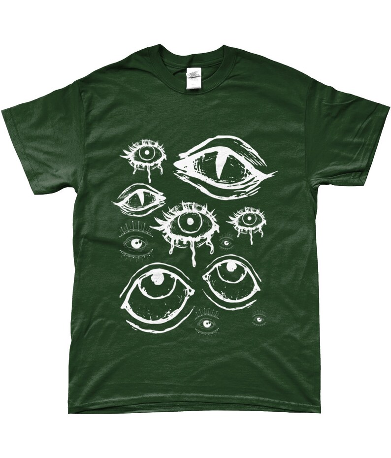May include: Dark green t-shirt featuring a white graphic of various stylized eyes. The eyes have different shapes and sizes, with some appearing to be crying. The design is printed on a short-sleeved shirt.