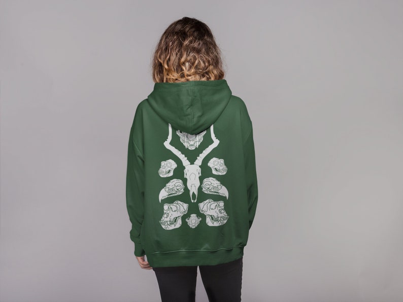 May include: A dark green hooded sweatshirt with a white graphic print of animal skulls on the back.