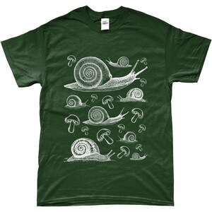 May include: A dark green t-shirt with a white graphic print of snails and mushrooms. The snails are drawn in a vintage style and are surrounded by mushrooms.