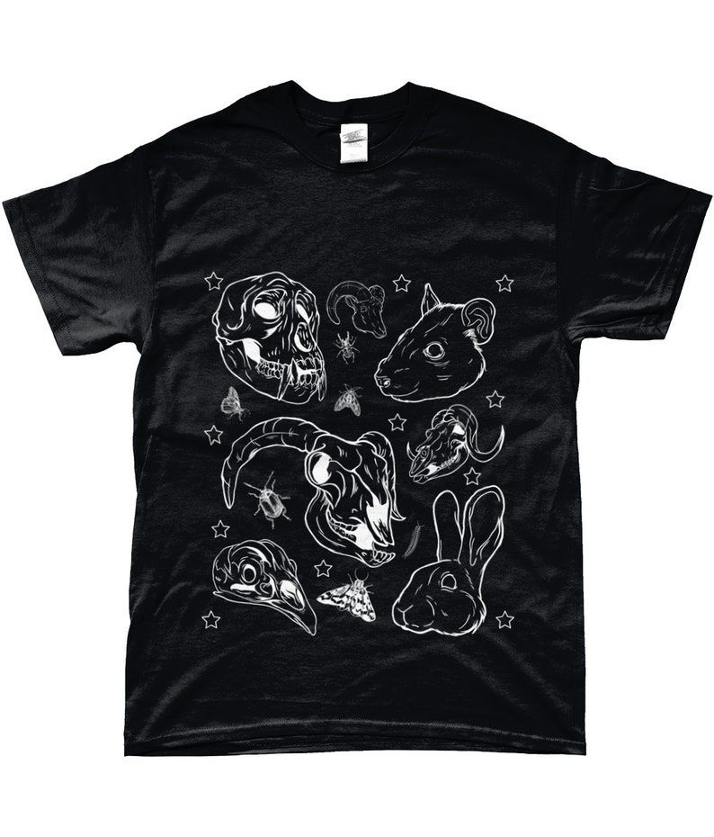 May include: Black t-shirt with a white graphic print of various animal skulls, insects, and a rabbit. The design includes a monkey skull, a ram skull, a rat skull, a deer skull, a bird skull, and a rabbit. The design is surrounded by white stars.