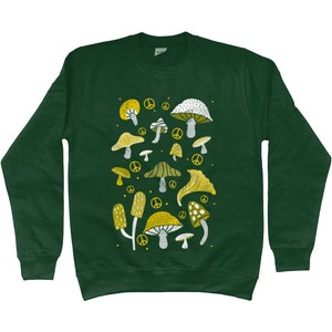 Puede incluir: Una sudadera verde oscuro con un dise&ntilde;o de setas blancas y amarillas. Las setas son de varias formas y tama&ntilde;os, y algunas tienen s&iacute;mbolos de paz junto a ellas.