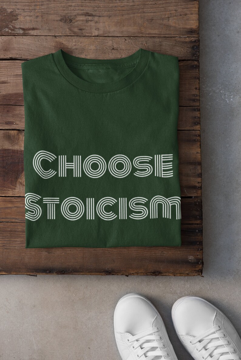 May include: A dark green t-shirt with the text "CHOOSE STOICISM" in white outlined letters.