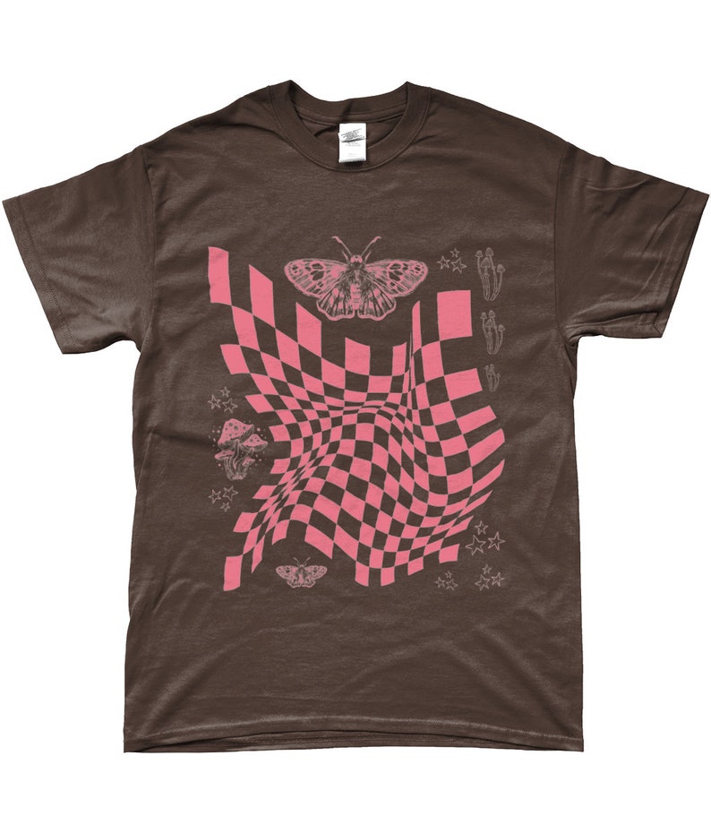 May include: A brown t-shirt with a pink checkered pattern, a butterfly, mushrooms, and stars. The checkered pattern is distorted, creating a wavy effect.