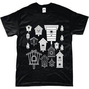 May include: Black t-shirt featuring a white design of various birdhouses in different shapes and sizes.