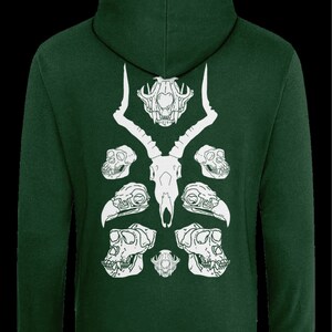 May include: A dark green hooded sweatshirt with a white graphic print of animal skulls. The graphic features a deer skull with antlers, two monkey skulls, and two bird skulls.