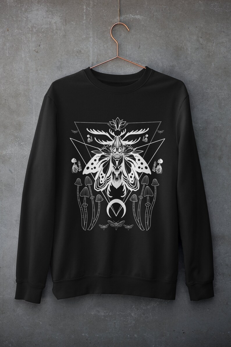May include: Black sweatshirt with a white graphic design of a moth with antlers, mushrooms, and a crescent moon. The design is surrounded by a triangle.