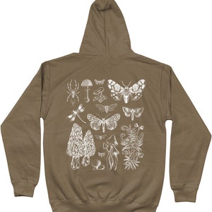 May include: A brown hooded sweatshirt with a white print of various insects, mushrooms, and plants. The print includes a spider, dragonfly, butterflies, and mushrooms.