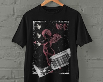 May include: Black t-shirt featuring a distressed graphic. The graphic includes a pink cherub with wings, a barcode, and the text "OWN YOUR GODS". The design also incorporates images of faces and a textured background.